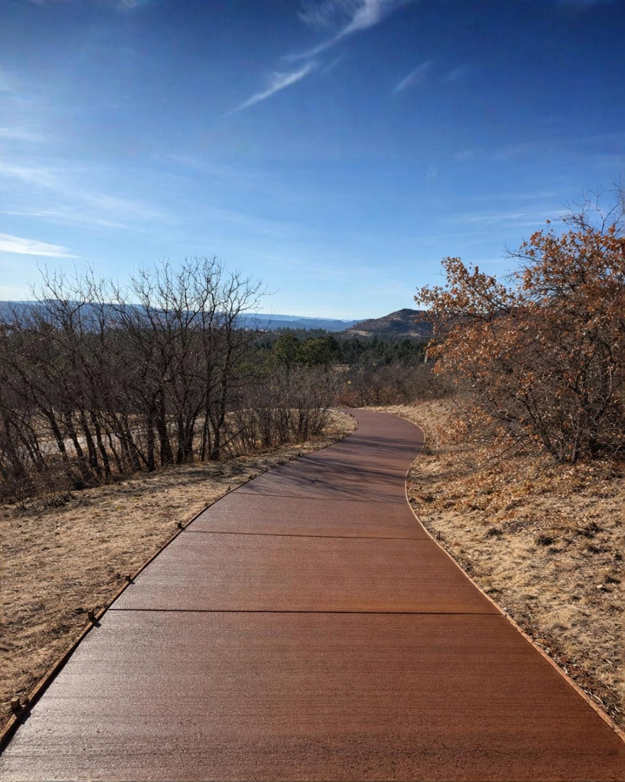 Integrally colored and textured concrete pathway with mountain view