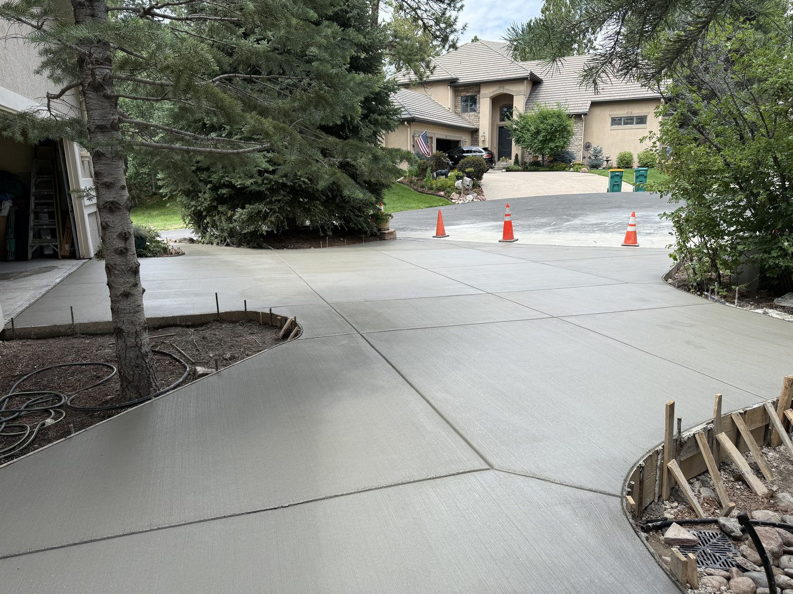 Freshly poured wraparound concrete driveway at a Front Range home
