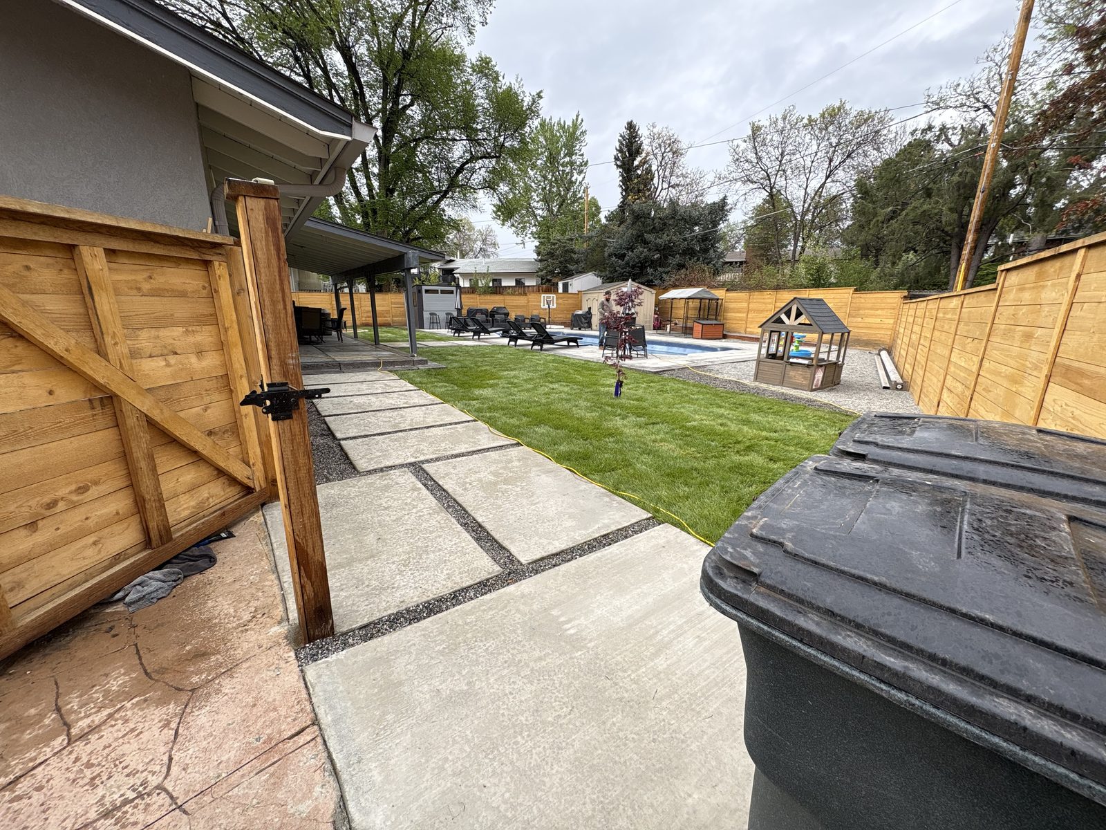 Concrete walkway and slab pads beside new turf